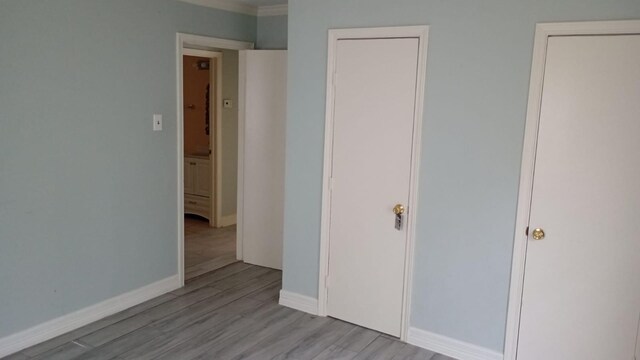 unfurnished bedroom featuring light wood-type flooring