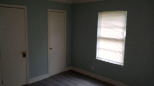 unfurnished room with hardwood / wood-style flooring