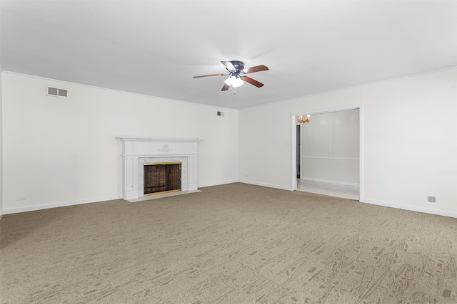 unfurnished living room featuring a fireplace, ceiling fan, and carpet floors