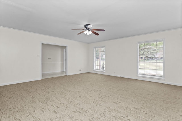 carpeted spare room with ceiling fan