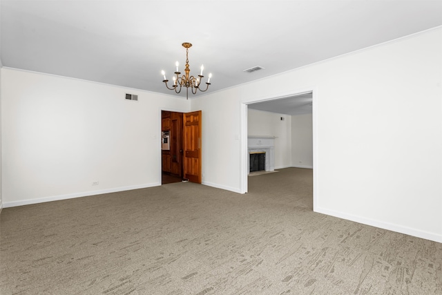 empty room with crown molding, a notable chandelier, and carpet floors