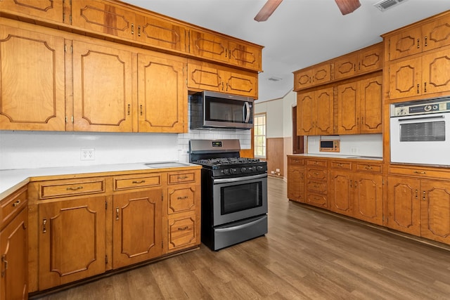 kitchen featuring appliances with stainless steel finishes, wood-type flooring, and ceiling fan