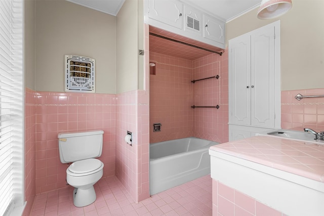 bathroom featuring tile walls, tile patterned flooring, toilet, and vanity