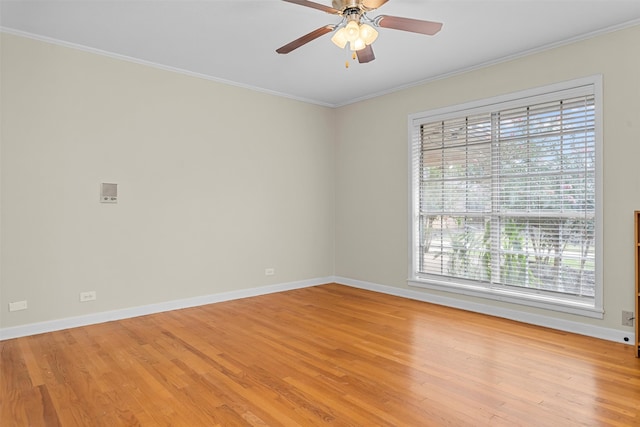 spare room with light wood-type flooring, ceiling fan, and ornamental molding