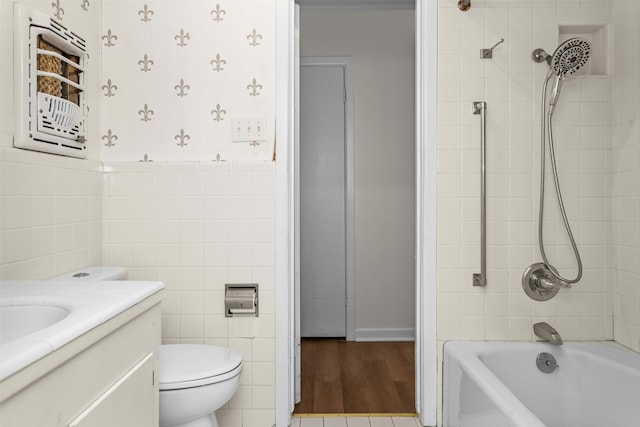 full bathroom with tile walls, wood-type flooring, toilet, and vanity