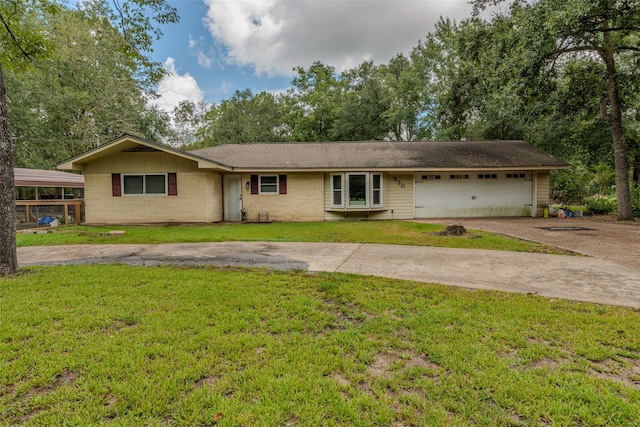 ranch-style home featuring a garage and a front lawn