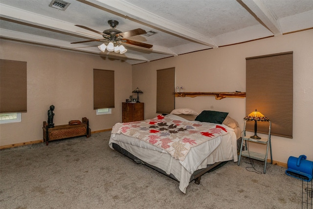 bedroom featuring a textured ceiling, carpet flooring, ceiling fan, and beamed ceiling