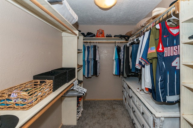 spacious closet featuring dark carpet