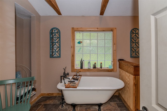 bathroom featuring a bathtub and beam ceiling