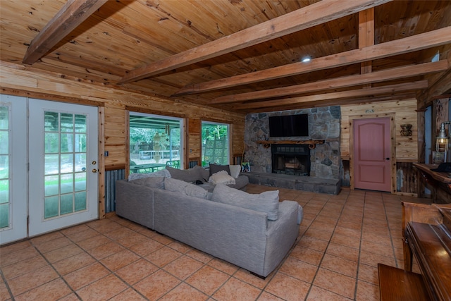 tiled living room with wood ceiling, a wealth of natural light, a fireplace, and beamed ceiling