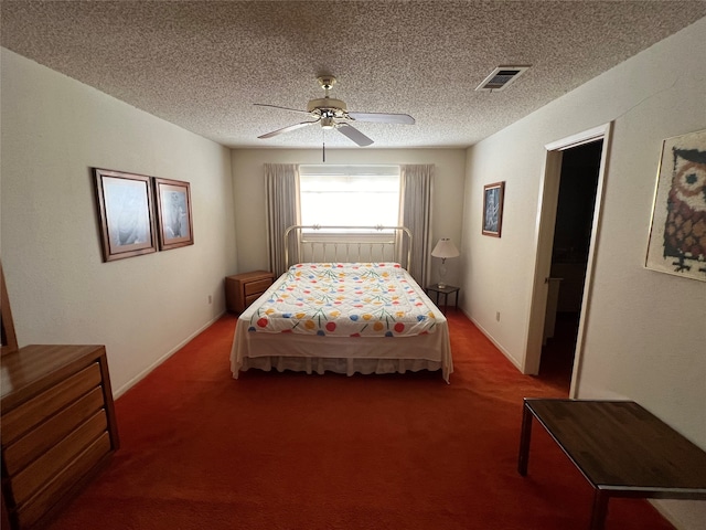 carpeted bedroom with ceiling fan and a textured ceiling