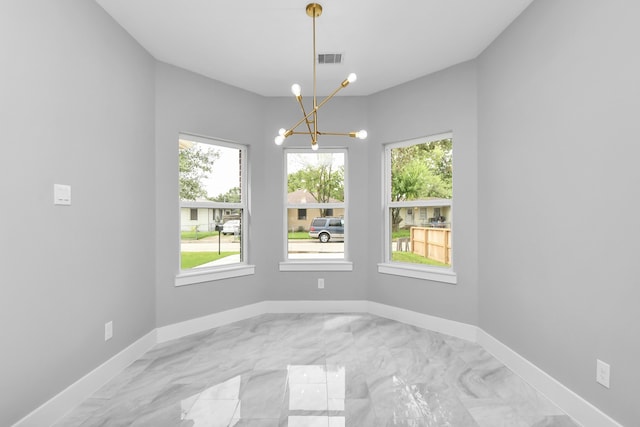 dining area featuring a wealth of natural light and an inviting chandelier