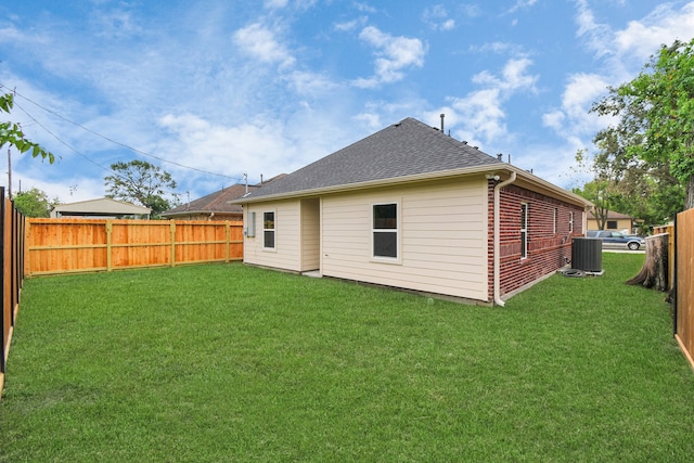 rear view of property featuring a lawn