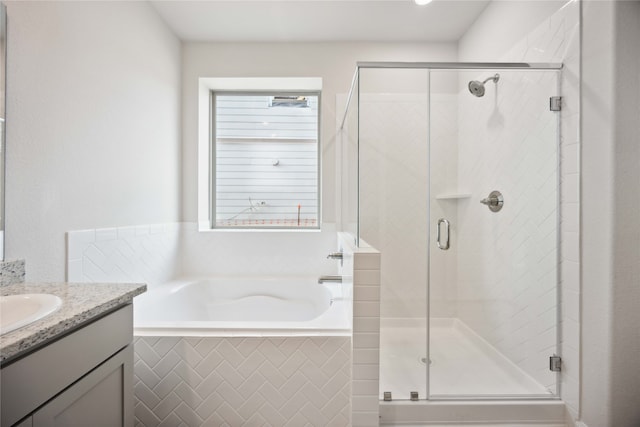 bathroom featuring separate shower and tub, a wealth of natural light, and vanity