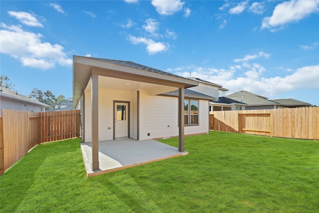 back of house with a yard and a patio area