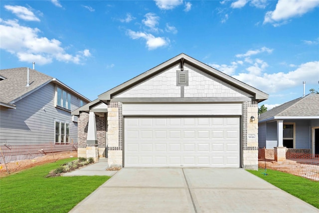 craftsman-style home with a front yard and a garage