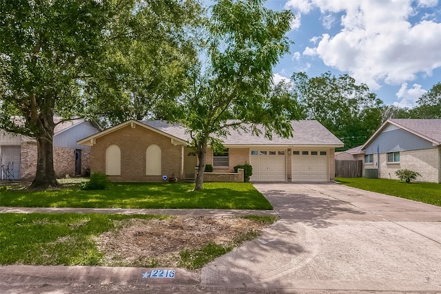 ranch-style home featuring a garage and a front yard