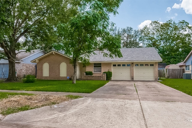 ranch-style home featuring a front lawn, a garage, and central AC