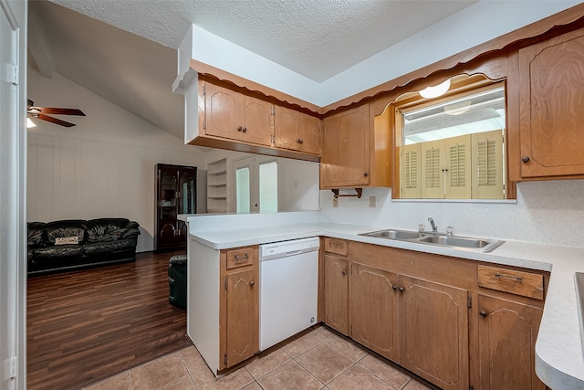 kitchen featuring dishwasher, light hardwood / wood-style flooring, sink, lofted ceiling, and ceiling fan