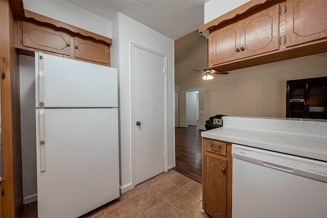 kitchen featuring a textured ceiling, ceiling fan, light wood-type flooring, and white appliances