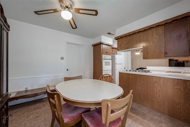 interior space with sink and ceiling fan