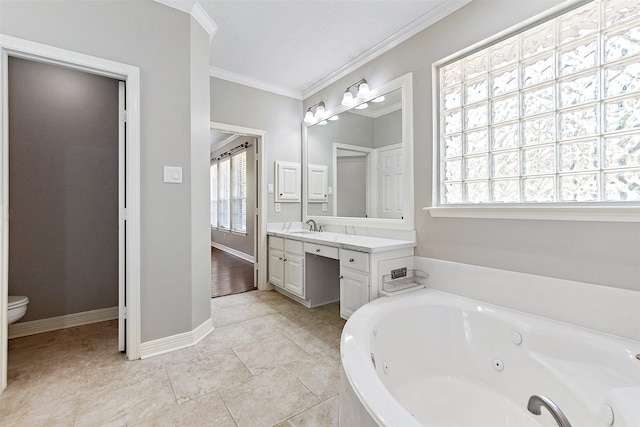 bathroom featuring toilet, a wealth of natural light, a tub to relax in, and vanity