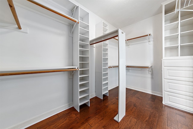 walk in closet featuring dark wood-type flooring