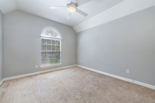 carpeted spare room featuring lofted ceiling and ceiling fan