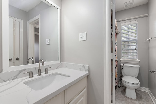 bathroom featuring toilet and vanity