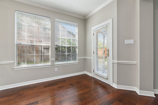 spare room with dark wood-type flooring and crown molding