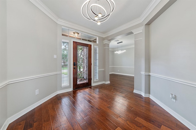 foyer entrance with a notable chandelier, dark hardwood / wood-style flooring, and crown molding