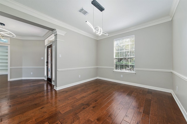 unfurnished room with dark hardwood / wood-style flooring, ornamental molding, and a notable chandelier