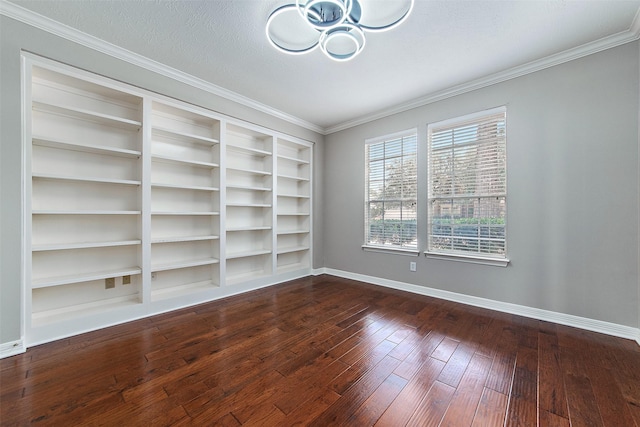 spare room with a textured ceiling, dark hardwood / wood-style floors, built in features, and ornamental molding