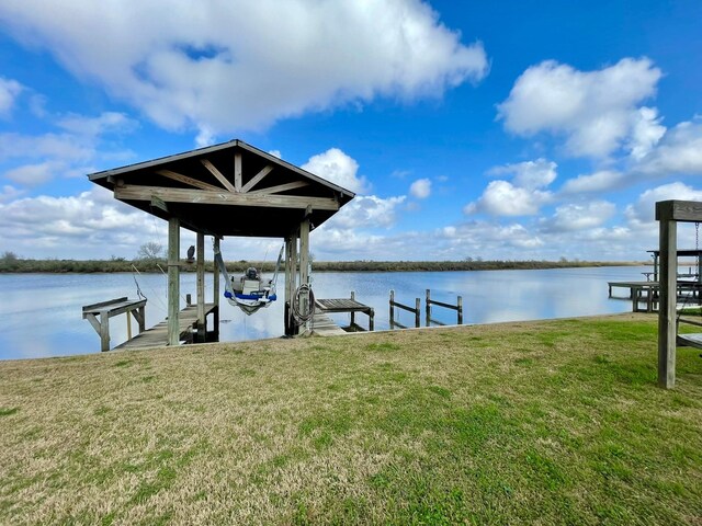 dock area featuring a yard and a water view