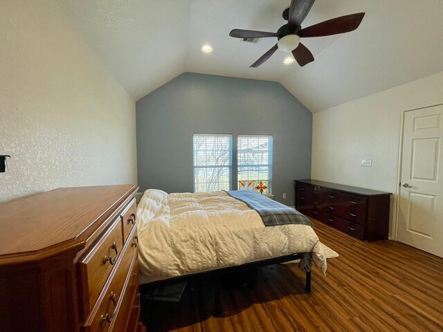 bedroom with lofted ceiling, visible vents, ceiling fan, and wood finished floors