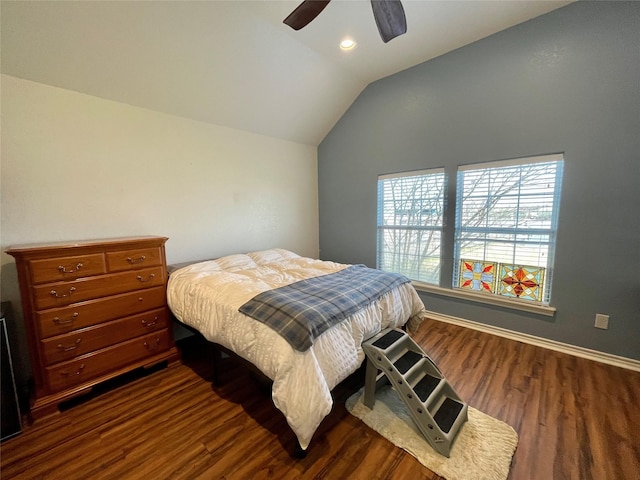 bedroom with ceiling fan, lofted ceiling, and dark hardwood / wood-style flooring