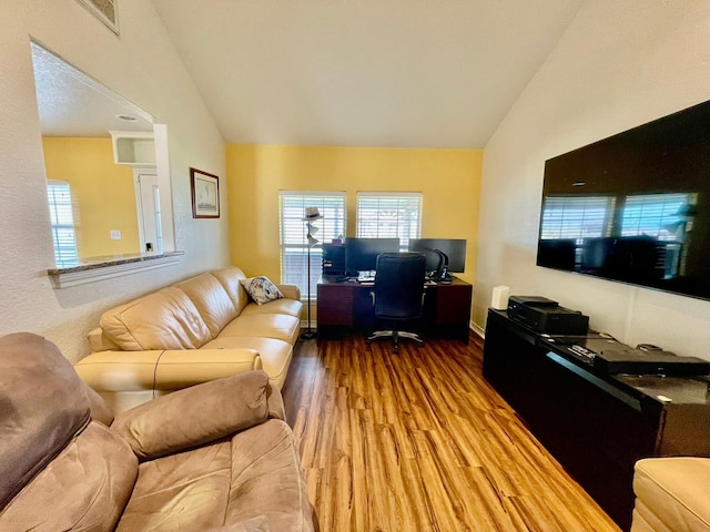 living room with hardwood / wood-style flooring and vaulted ceiling