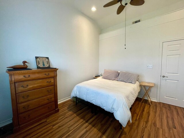 bedroom featuring a ceiling fan, baseboards, visible vents, and wood finished floors