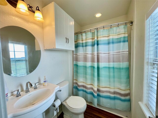 full bathroom featuring shower / bath combo, sink, and toilet