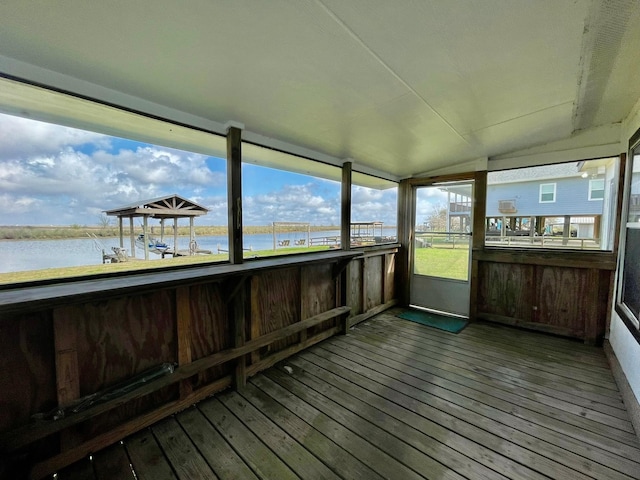 unfurnished sunroom with a water view and lofted ceiling