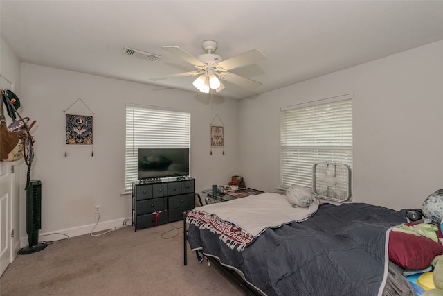 bedroom featuring ceiling fan and carpet