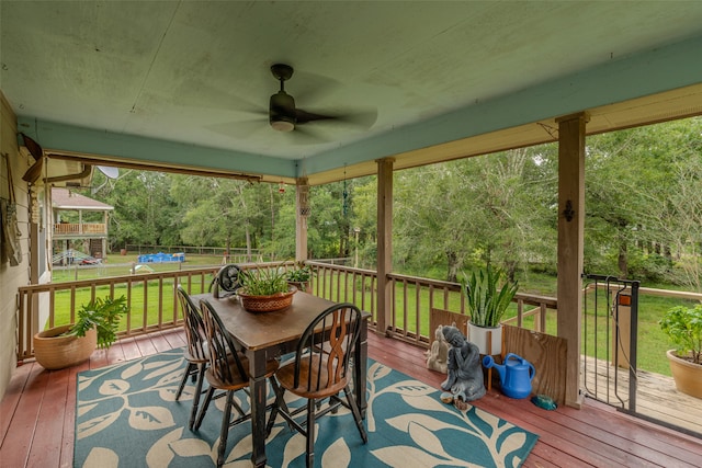 sunroom / solarium featuring ceiling fan