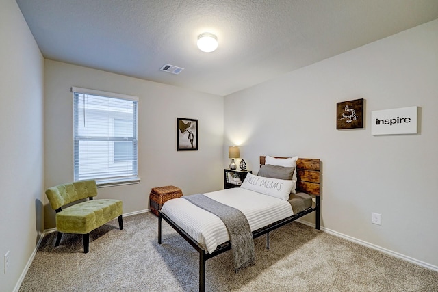 14242 W Pine Heart Dr, Conroe, TX 77302 - bedroom featuring light carpet and a textured ceiling
