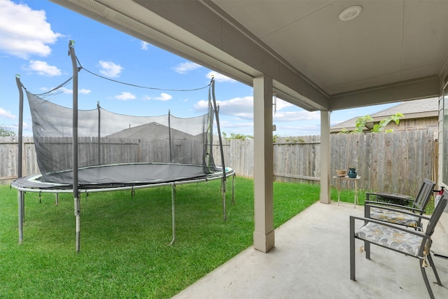 view of yard with a patio area and a trampoline