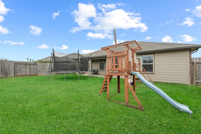 view of yard featuring a trampoline and a playground