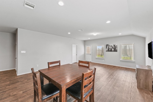 dining space with dark wood-type flooring and lofted ceiling