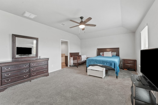 carpeted bedroom featuring lofted ceiling, ceiling fan, and ensuite bathroom