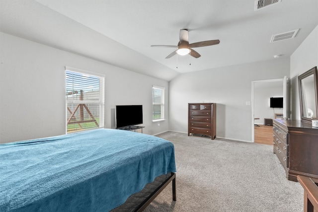 bedroom with lofted ceiling, ceiling fan, and carpet