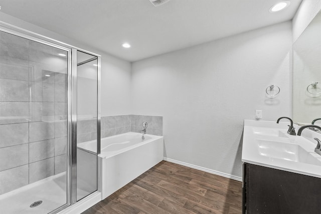 bathroom featuring vanity, separate shower and tub, and wood-type flooring