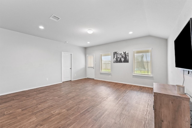 unfurnished living room featuring lofted ceiling and hardwood / wood-style flooring